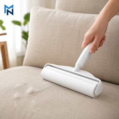 Person using a white roller brush to clean a beige sofa